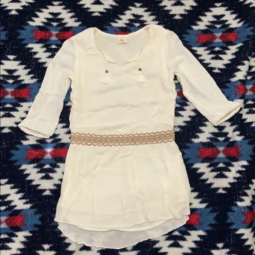 White dress with a tan flower stripe on the waist